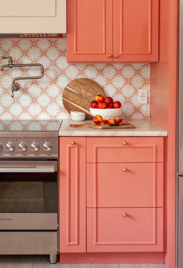 Coral drawer stack beside the range with patterned tile