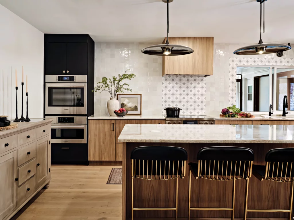 Walnut cabinetry run with integrated range and tile backsplash