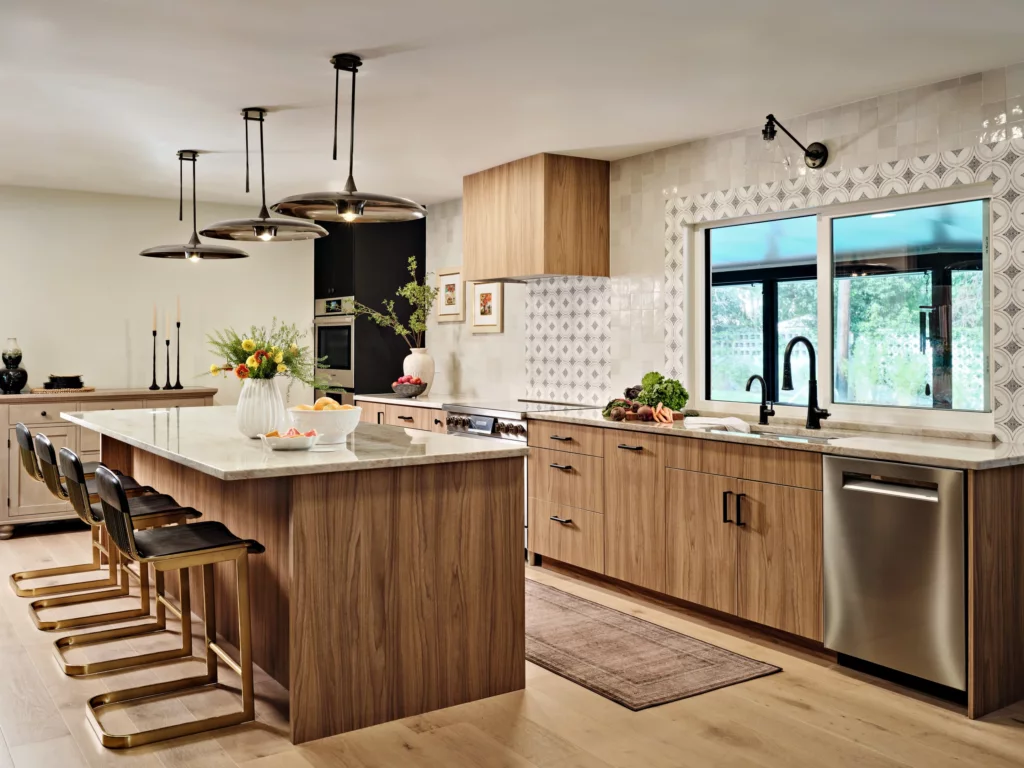 Walnut slab kitchen with black tall units and a quartz island, Winter Park