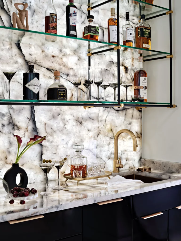 Glass shelving over black bar cabinetry