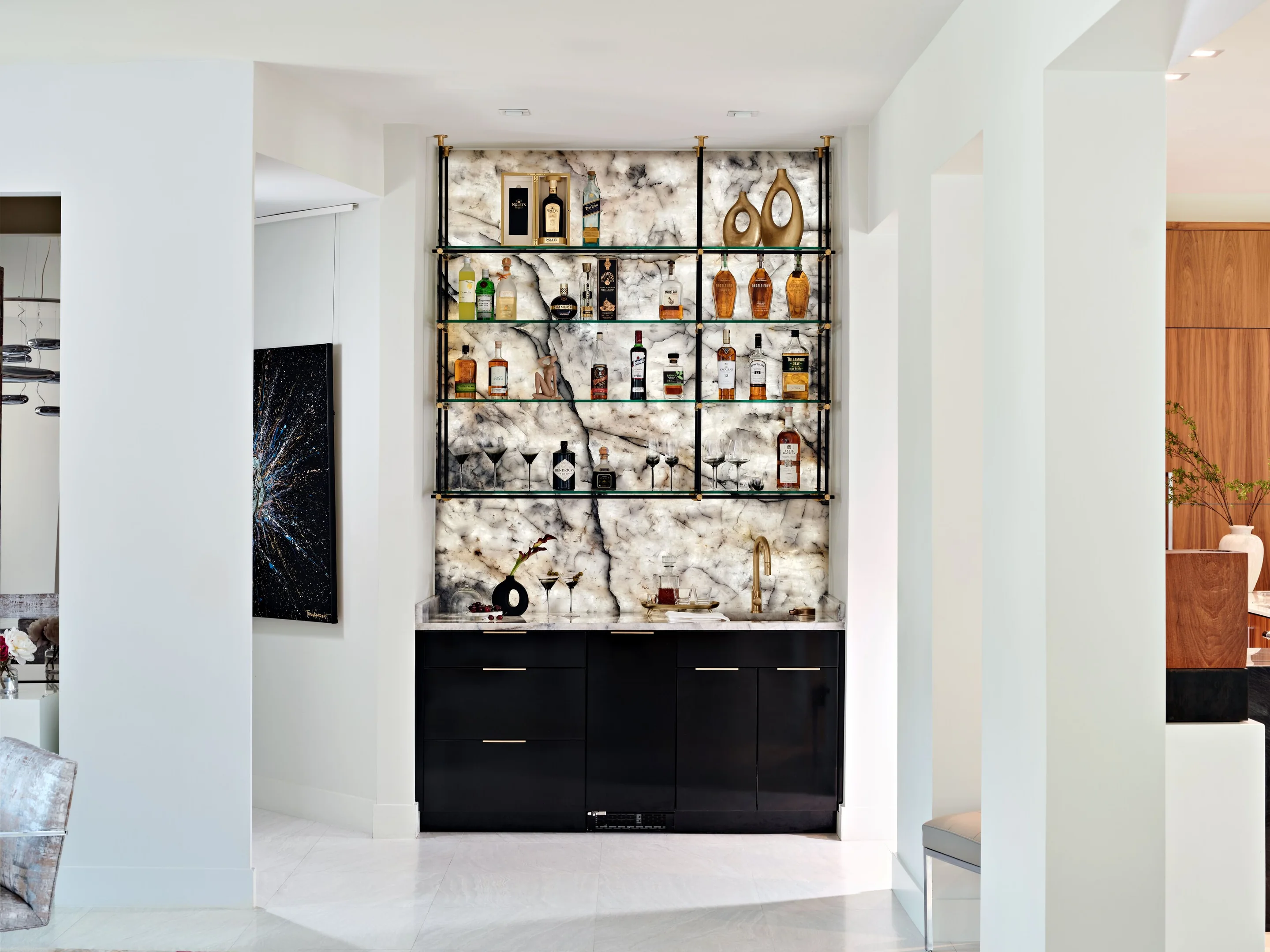 High-gloss black bar cabinetry with backlit stone and glass shelving, Winter Park
