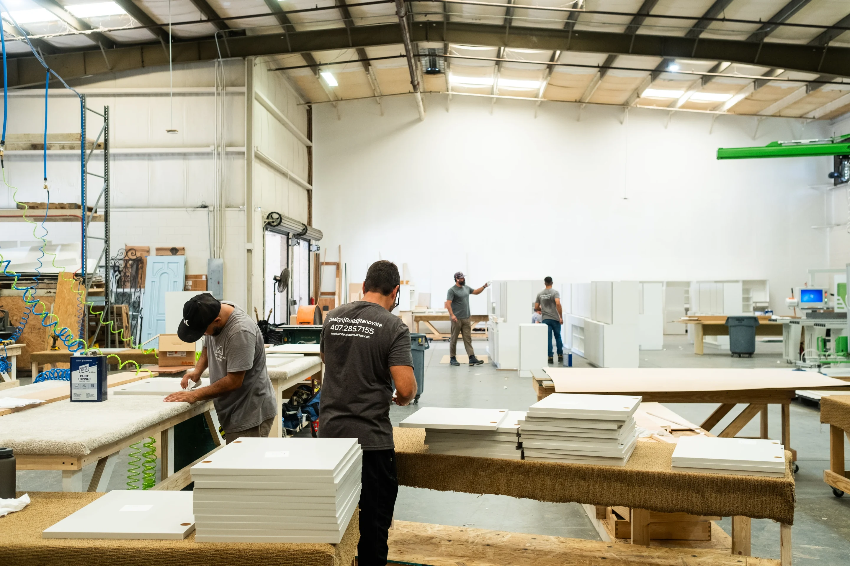 Unity Cabinetry workshop team preparing cabinet fronts